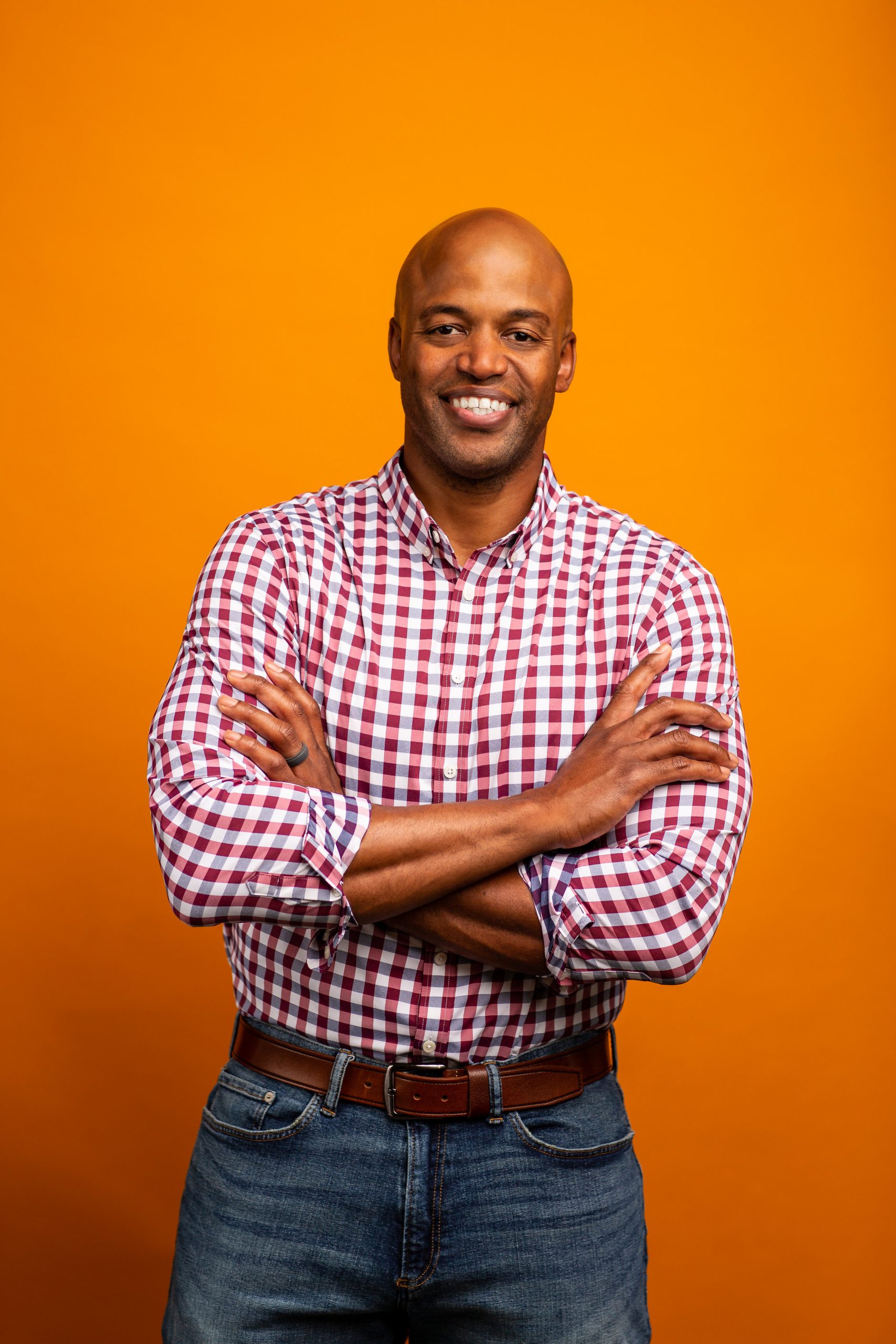 headshot photographers in columbus produced this professional headshot on an orange background